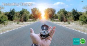 A hand holding a compass on a road leading to a bright horizon. Text reads "Navigating Change." Various logos are present.