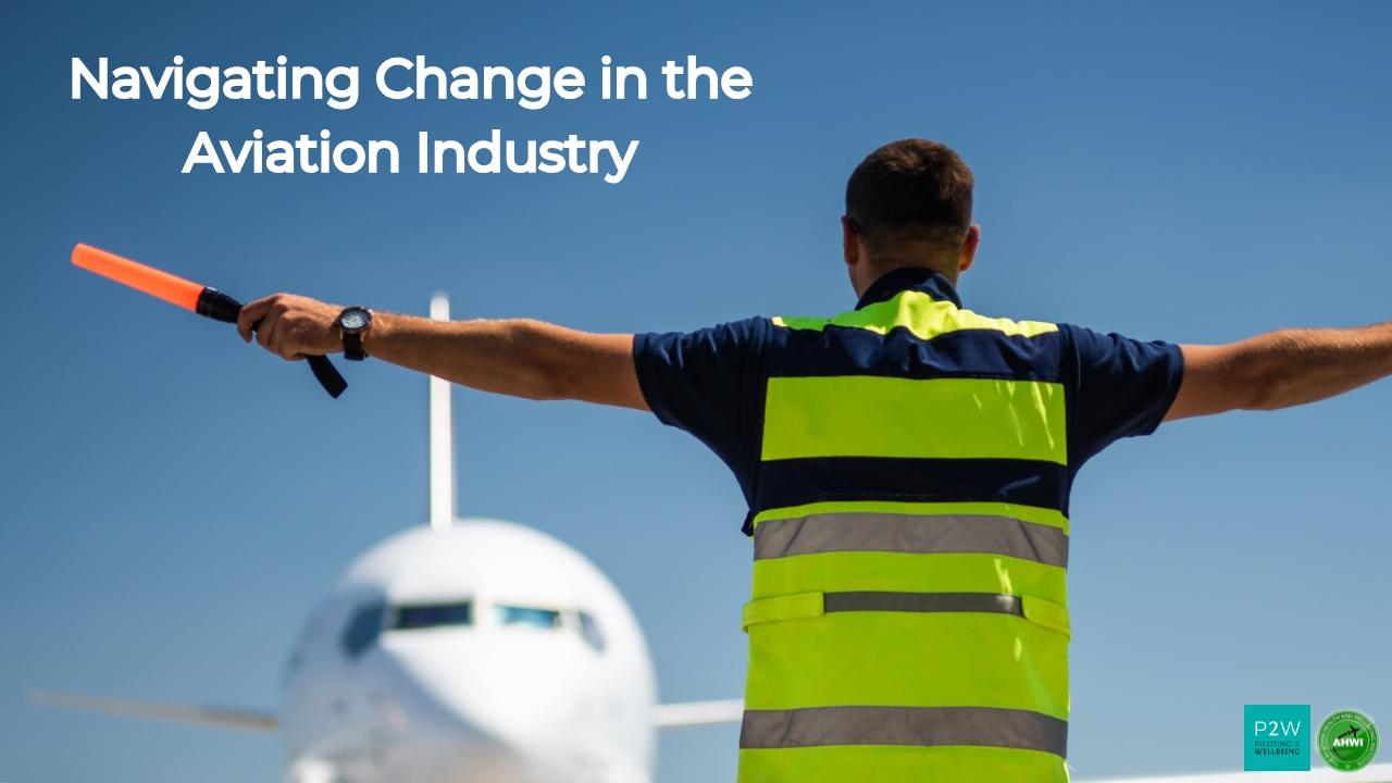 Airport ground crew member in a high-visibility vest directing an approaching airplane on a runway under a clear blue sky. Text reads "Navigating Change in the Aviation Industry.